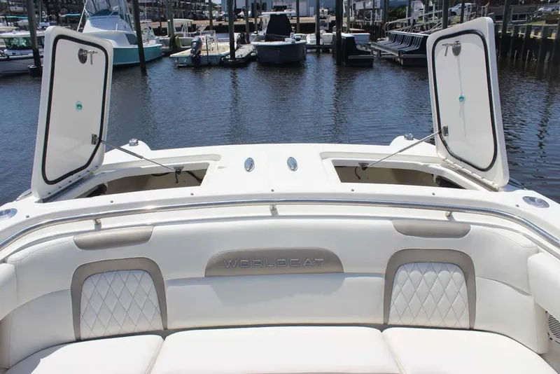 Slide: The Image of 2023 World Cat 280 CC-X boat interior with open storage compartments at marina. - 4