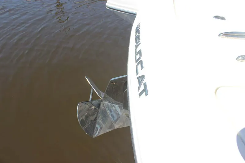 Slide: The Image of 2023 World Cat 280 CC-X boat with visible anchor, docked on calm water. - 7