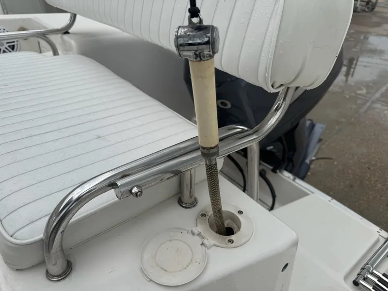 Slide: The Image of 2004 Robalo R230 Center Console boat seat with rod holder and stainless steel railing. - 12