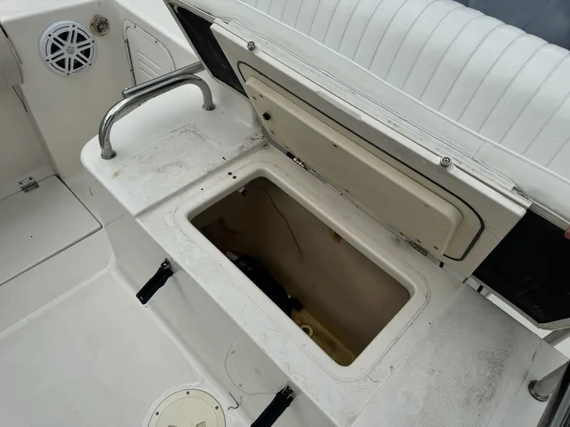 Slide: The Image of Open storage compartment on a 2004 Robalo R230 Center Console boat interior. - 14