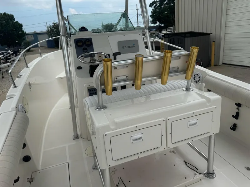 Slide: The Image of 2004 Robalo R230 Center Console boat interior with rod holders and storage compartments. - 16