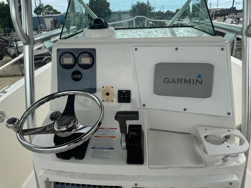 Slide: The Image of 2004 Robalo R230 Center Console dashboard with Garmin navigation system and steering wheel. - 17