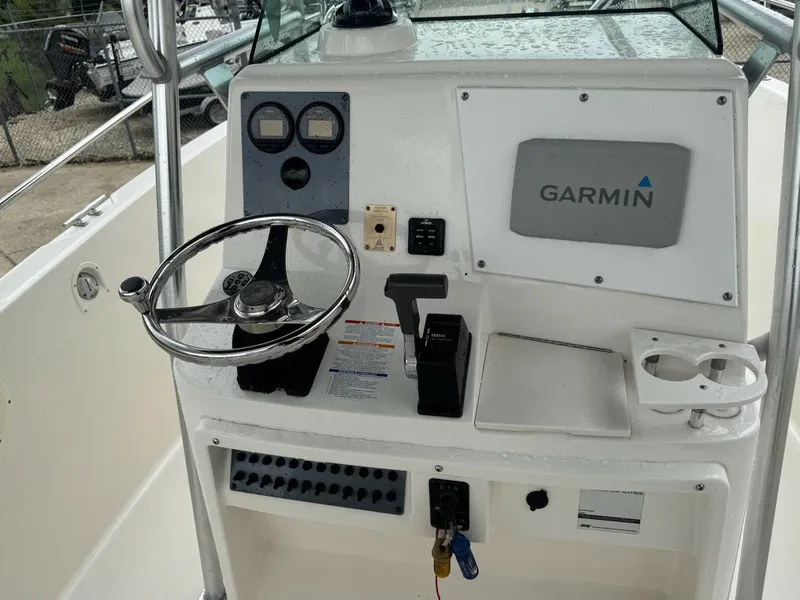 Slide: The Image of 2004 Robalo R230 Center Console helm with Garmin navigation system and steering wheel. - 18