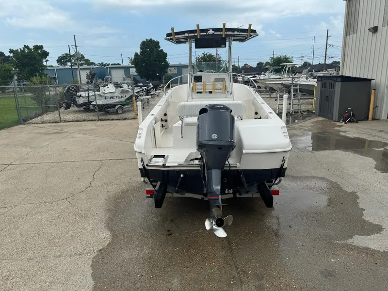 Slide: The Image of 2004 Robalo R230 Center Console boat with Yamaha outboard motor, parked outdoors. - 2