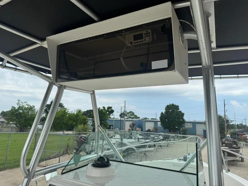 Slide: The Image of 2004 Robalo R230 Center Console boat with overhead electronics box and windshield. - 20