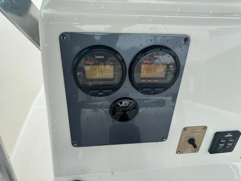 Slide: The Image of 2004 Robalo R230 Center Console dashboard with Yamaha tachometer and speedometer. - 24