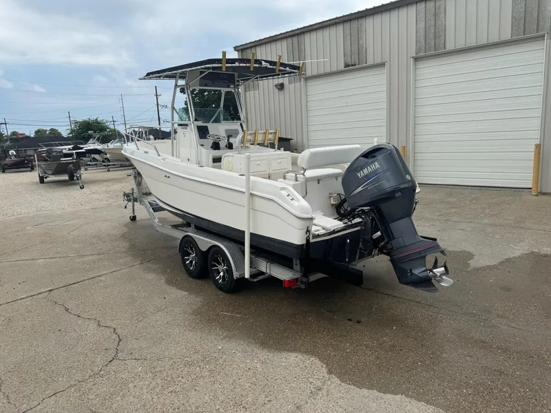 Slide: The Image of 2004 Robalo R230 Center Console boat with Yamaha outboard motor on a trailer. - 3