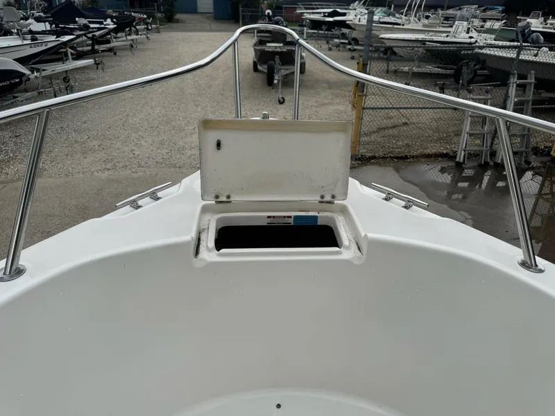Slide: The Image of 2004 Robalo R230 Center Console boat bow with open storage compartment. - 31