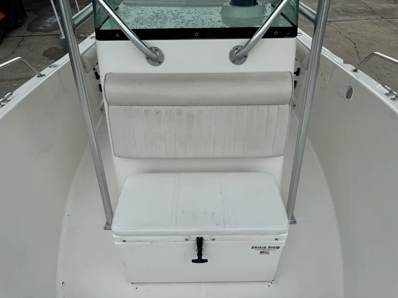 Slide: The Image of 2004 Robalo R230 Center Console boat interior with seating and storage. - 34