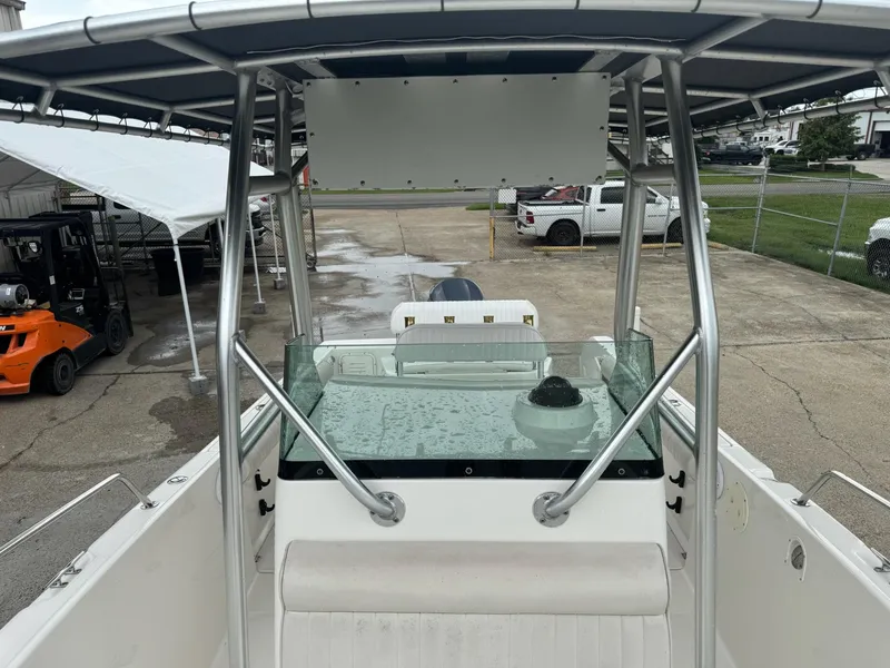 Slide: The Image of 2004 Robalo R230 Center Console boat with T-top, parked in a lot. - 35