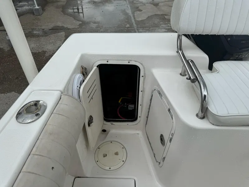 Slide: The Image of 2004 Robalo R230 Center Console boat interior with open storage compartment. - 37