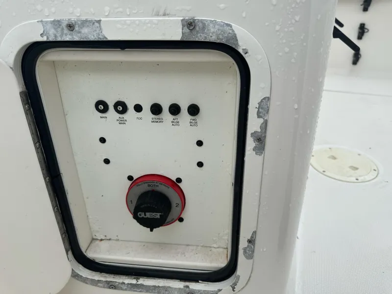 Slide: The Image of Control panel on a 2004 Robalo R230 Center Console boat, featuring various switches and a dial. - 38