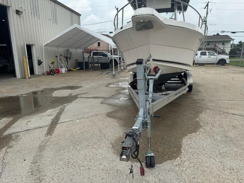 Slide: The Image of 2004 Robalo R230 Center Console boat on trailer in a parking lot. - 41