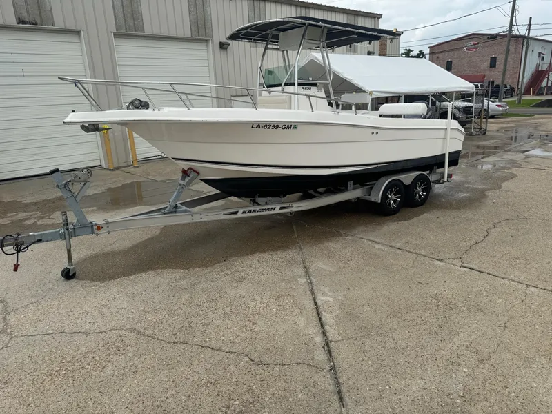 Slide: The Image of 2004 Robalo R230 Center Console boat on trailer in industrial setting. - 6