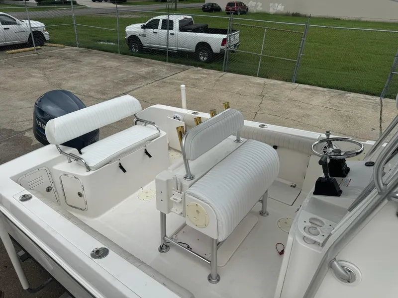 Slide: The Image of 2004 Robalo R230 Center Console boat interior with seating and steering wheel. - 9