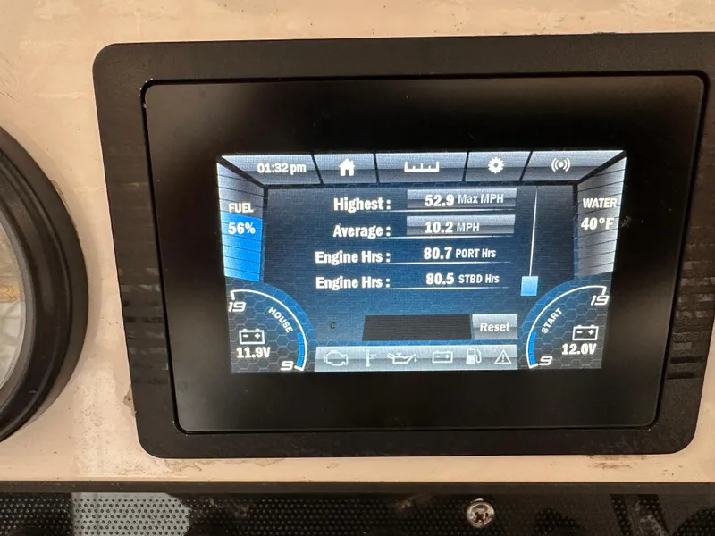 Slide: The Image of Yamaha Boats 2022 210 FSH Sport dashboard displaying speed, fuel, and engine hours. - 10