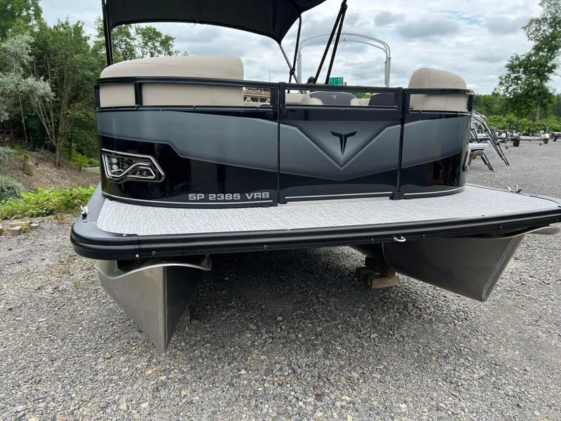 Slide: The Image of 2026 Tahoe Pontoon 2385 VRB on gravel, showcasing sleek design and modern features. - 3