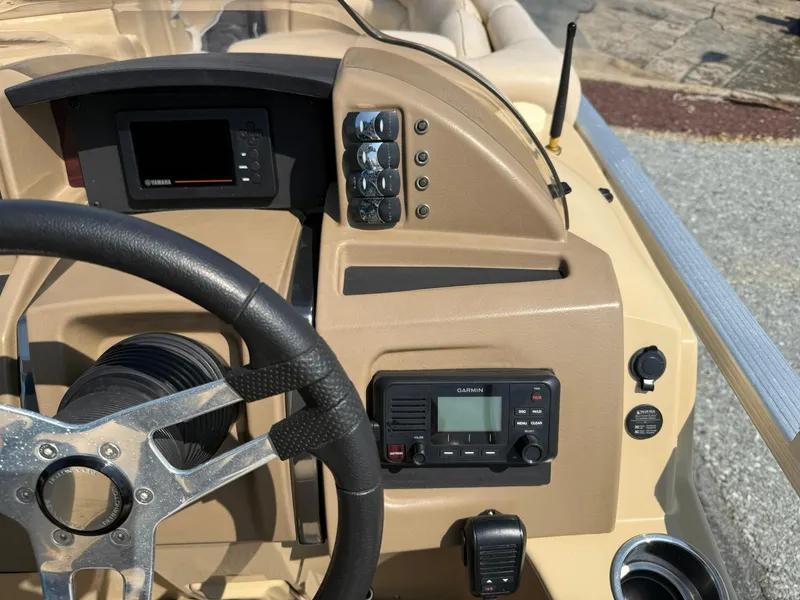 Slide: The Image of 2009 Bennington 2275QXi boat dashboard with steering wheel, Garmin device, and control panel. - 13