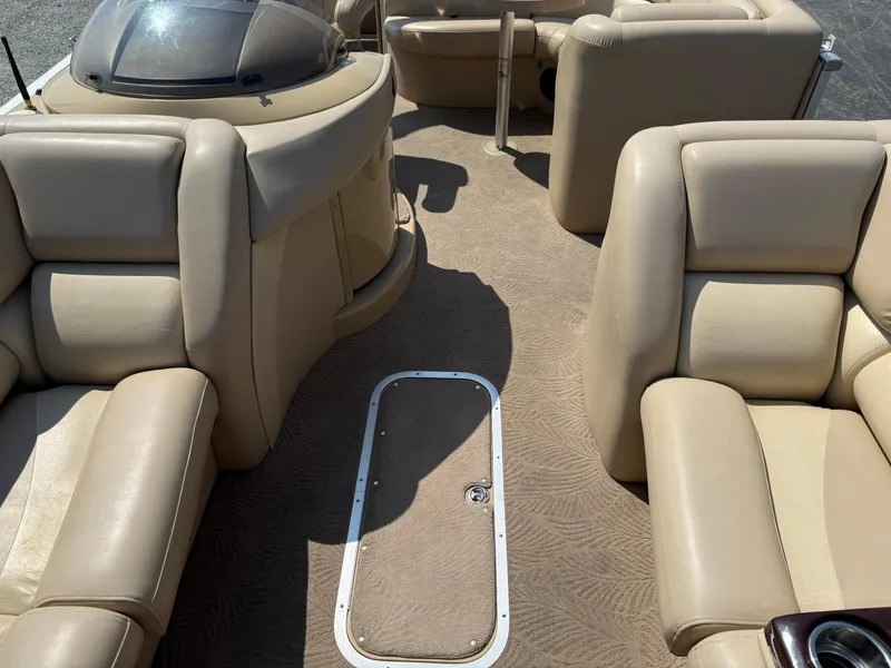 Slide: The Image of 2009 Bennington 2275QXi boat interior with beige leather seating and carpeted floor. - 9
