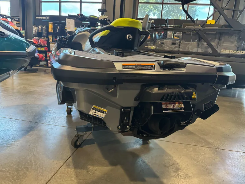 Slide: The Image of 2025 Sea-Doo RXT-X 325 jet ski displayed in showroom, rear view. - 2