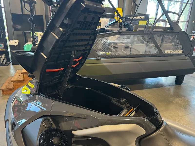 Slide: The Image of 2025 Sea-Doo RXT-X 325 with open storage compartment in showroom. - 3