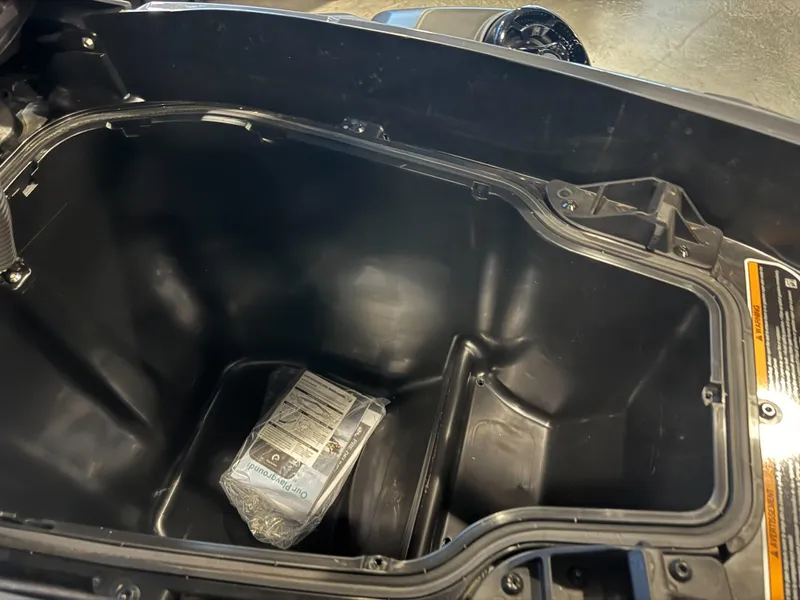 Slide: The Image of 2025 Sea-Doo RXT-X 325 storage compartment with manual inside. - 4