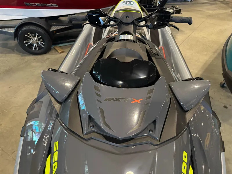 Slide: The Image of 2025 Sea-Doo RXT-X 325 jet ski, gray with yellow accents, displayed indoors. - 8