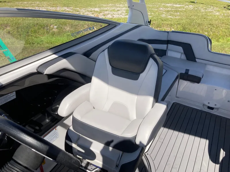 Slide: The Image of 2017 Yamaha Boats 242 Limited S E-Series interior with captain's chair and sleek design. - 17