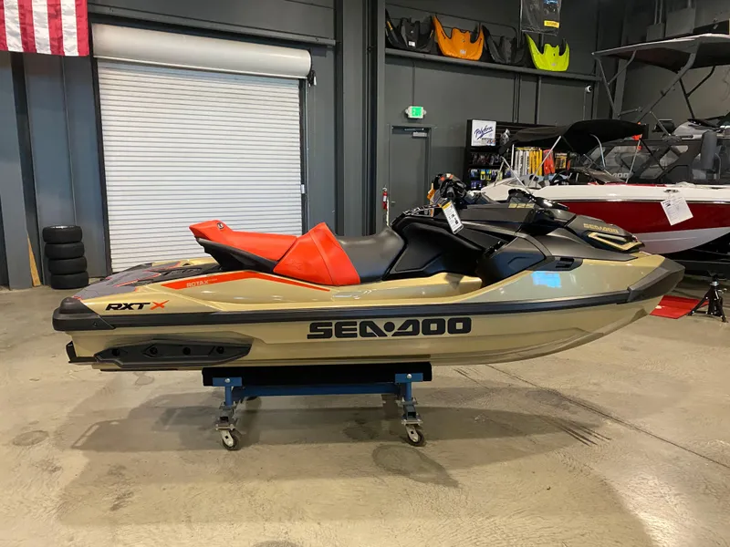 The Image of 2025 Sea-Doo RXT-X 325 jet ski in showroom, featuring sleek design and vibrant colors. - 0
