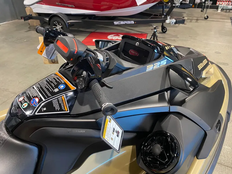 Slide: The Image of 2025 Sea-Doo RXT-X 325 jet ski, close-up of handlebars and dashboard in showroom. - 10