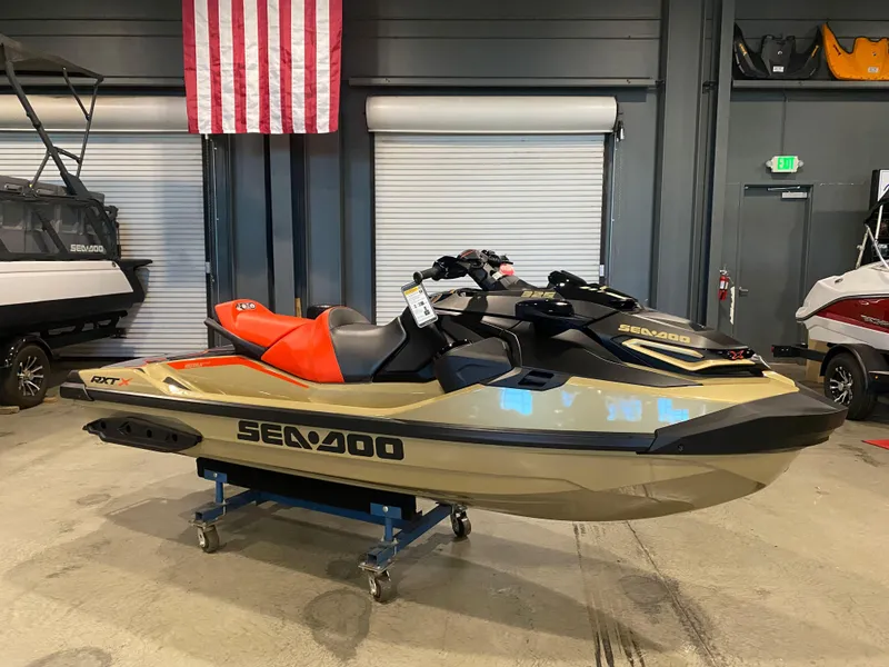 Slide: The Image of 2025 Sea-Doo RXT-X 325 jet ski in showroom, featuring sleek design and vibrant colors. - 3