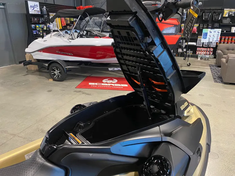 Slide: The Image of 2025 Sea-Doo RXT-X 325 with open storage compartment in showroom. - 9