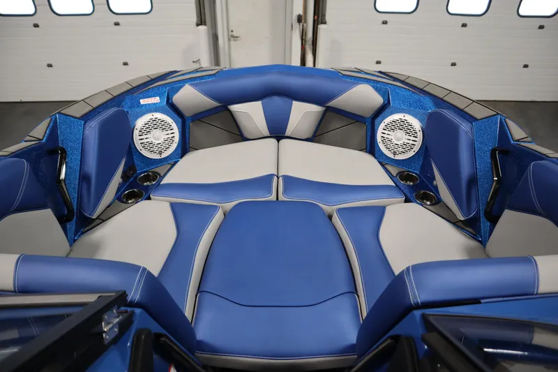 Slide: The Image of Interior of 2025 Centurion Fe23 boat with blue and gray seating and speakers. - 12
