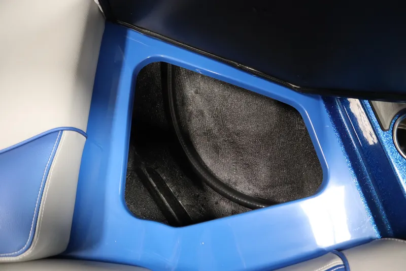 Slide: The Image of Interior storage compartment of 2025 Centurion Fe23 boat, featuring blue and gray seating. - 15