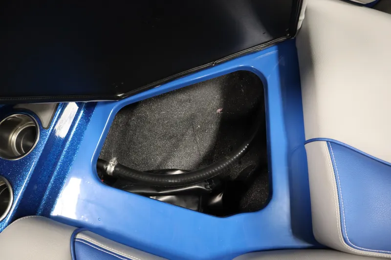 Slide: The Image of Centurion Fe23 2025 boat interior storage compartment with blue and gray seating. - 16