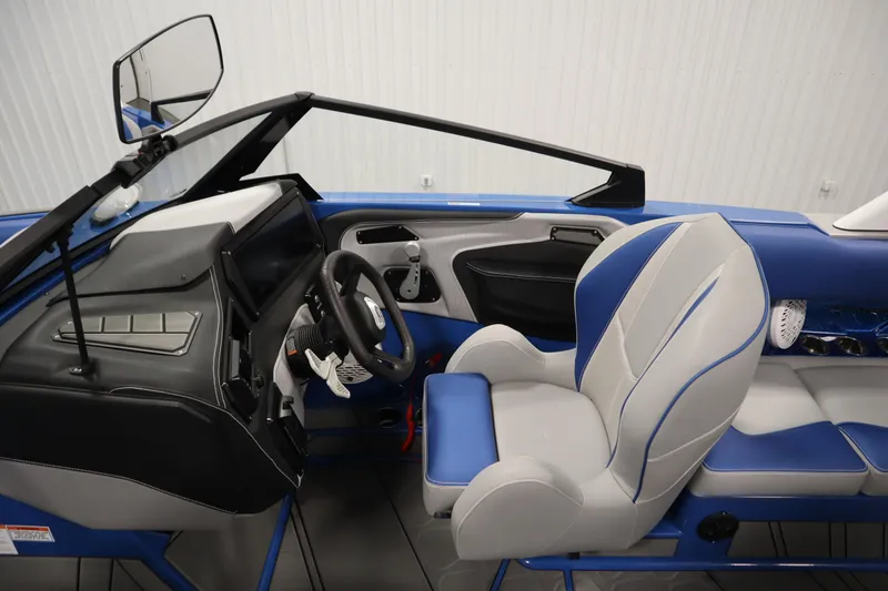Slide: The Image of Interior of 2025 Centurion Fe23 boat with modern dashboard and blue-gray seating. - 17