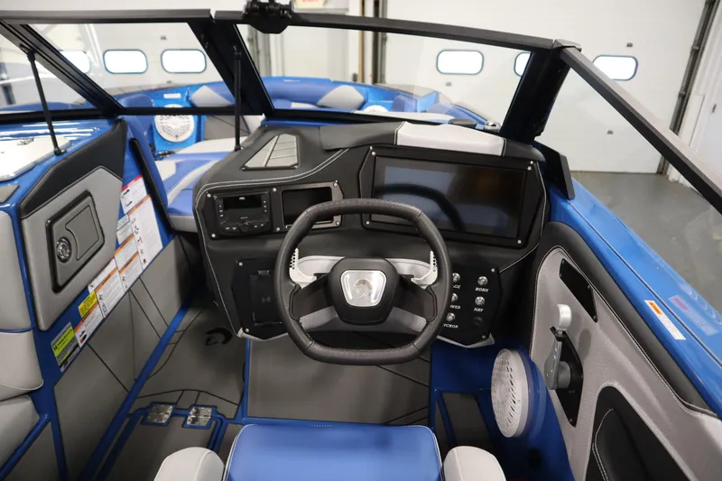 Slide: The Image of 2025 Centurion Fe23 boat interior with modern dashboard and steering wheel. - 18