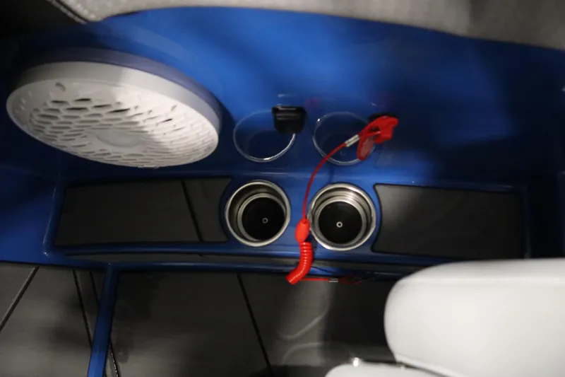 Slide: The Image of Interior of 2025 Centurion Fe23 boat with speaker, cup holders, and red safety lanyard. - 25