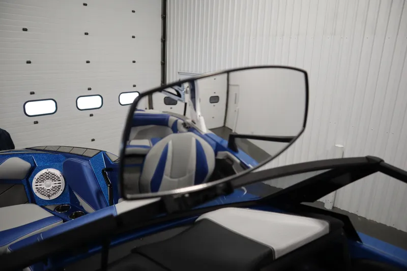 Slide: The Image of 2025 Centurion Fe23 boat interior with rearview mirror and blue seating. - 36