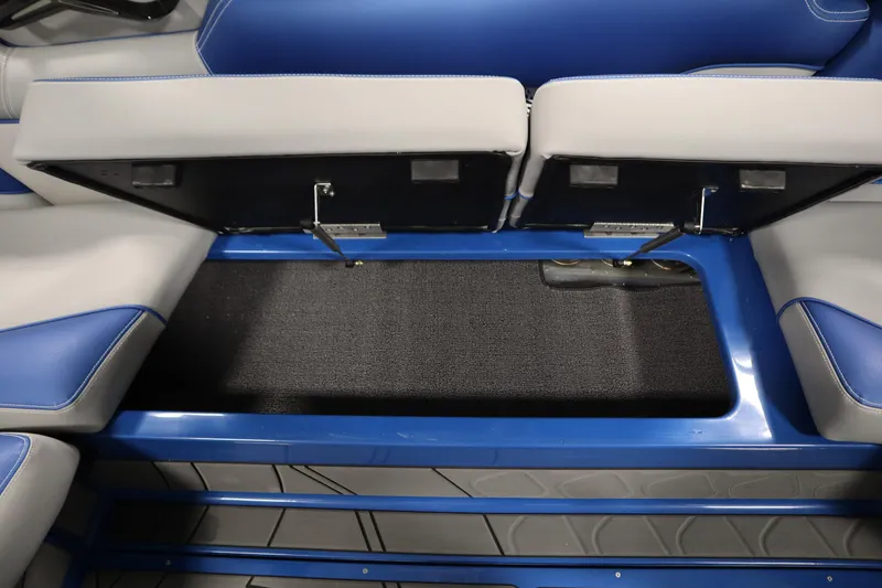 Slide: The Image of 2025 Centurion Fe23 boat interior storage compartment with blue and gray seating. - 40