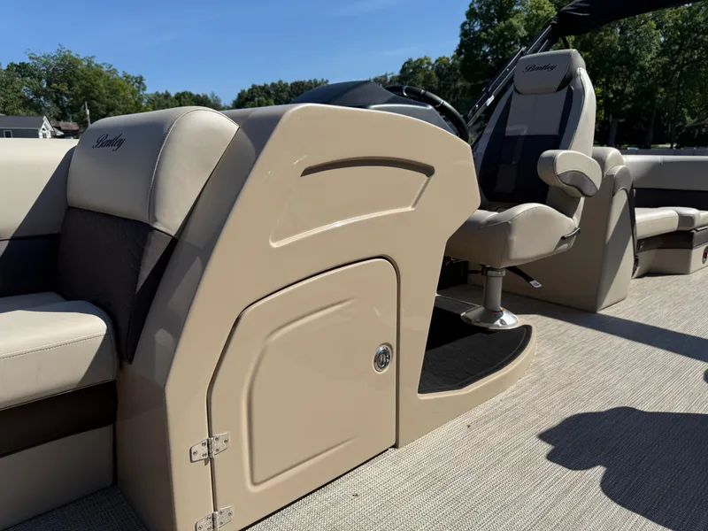 Slide: The Image of 2026 Bentley Pontoons Elite 220 Admiral interior with beige seating and helm. - 13