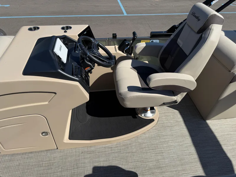 Slide: The Image of 2026 Bentley Pontoons Elite 220 Admiral helm with steering wheel and captain's chair. - 18
