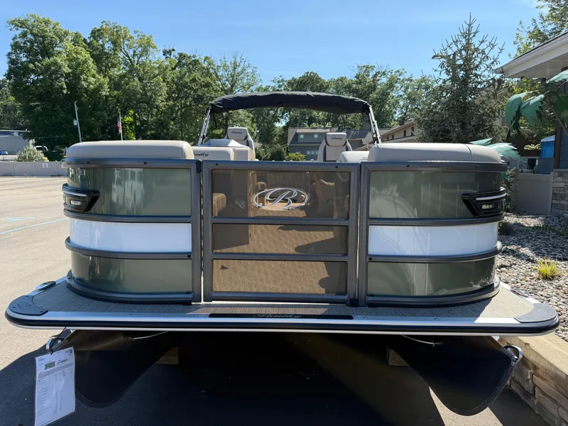 Slide: The Image of 2026 Bentley Pontoons Elite 220 Admiral, green and white, parked outdoors on a sunny day. - 2