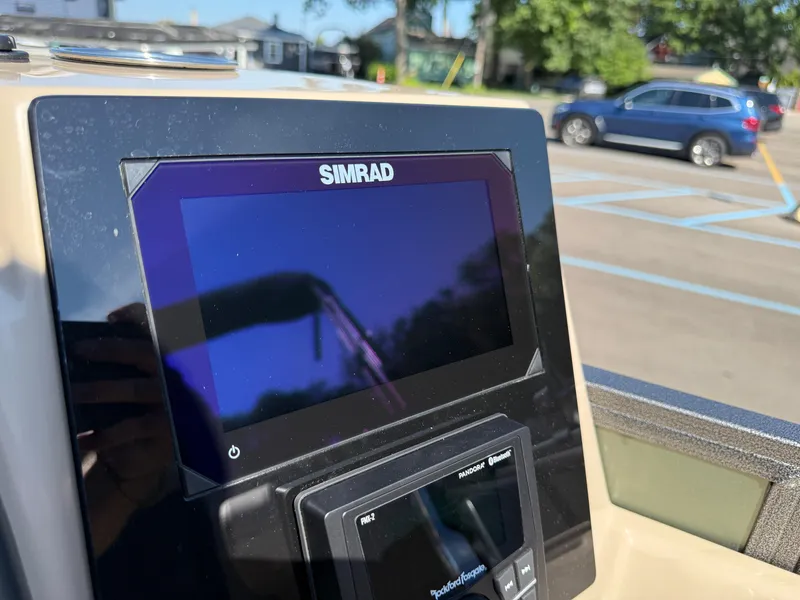 Slide: The Image of Simrad display on 2026 Bentley Pontoons Elite 220 Admiral dashboard in parking lot. - 23