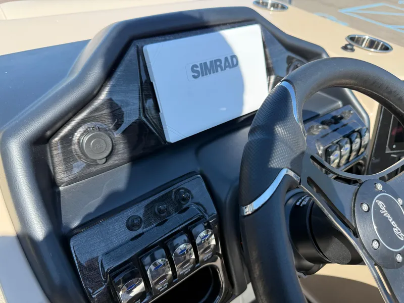 Slide: The Image of 2026 Bentley Pontoons Elite 220 Admiral dashboard with Simrad display and steering wheel. - 24