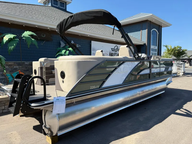 Slide: The Image of 2026 Bentley Pontoons Elite 220 Admiral pontoon boat displayed outdoors. - 4