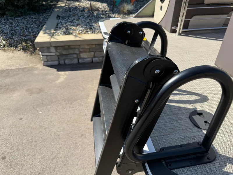 Slide: The Image of Ladder on 2026 Bentley Pontoons Elite 220 Admiral, docked on textured surface. - 7