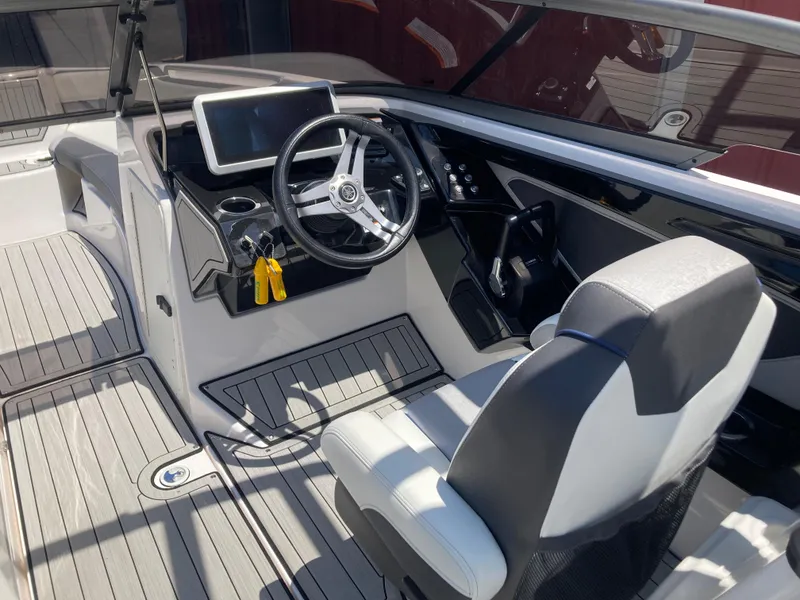 Slide: The Image of 2021 Yamaha Boats 252S cockpit with steering wheel and modern dashboard. - 13