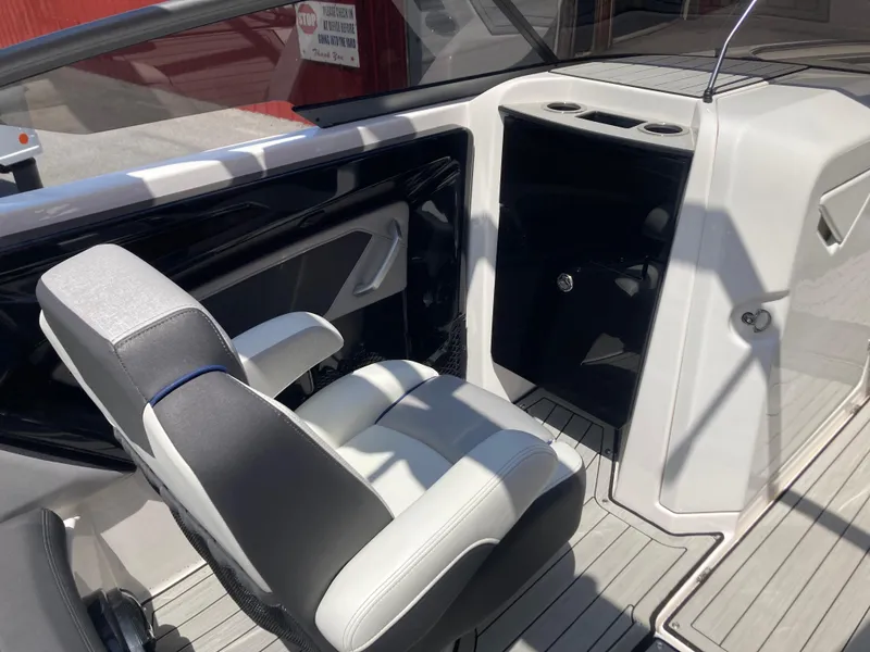 Slide: The Image of 2021 Yamaha Boats 252S interior with captain's chair and console, showcasing modern design. - 14