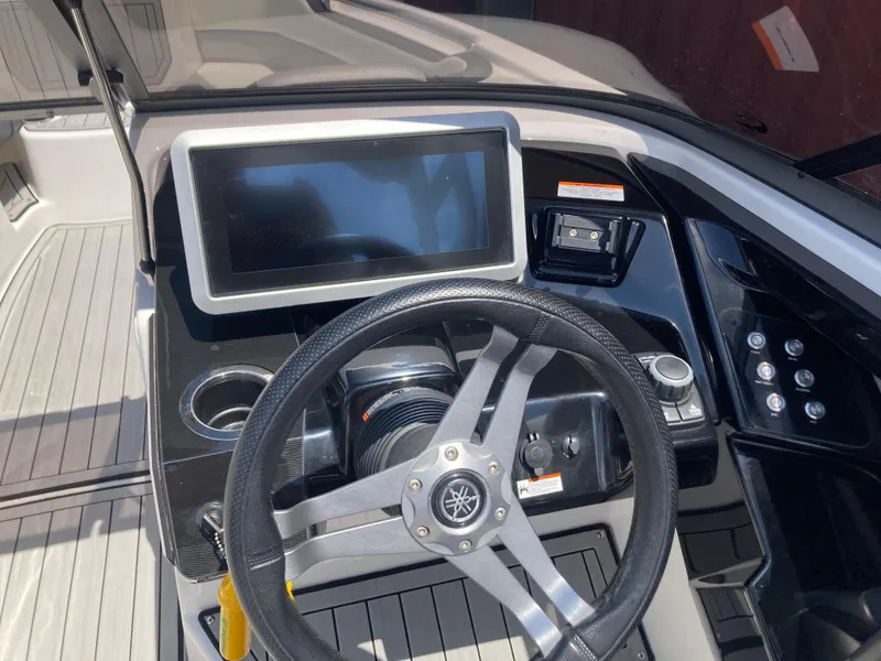 Slide: The Image of 2021 Yamaha Boats 252S dashboard with steering wheel and touchscreen display. - 15